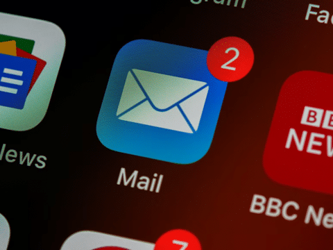 Closeup of an Email Icon on a Screen with a Badge Showing There are Two New Emails