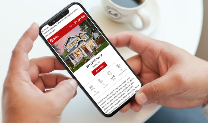 Cell phone showing a real-time MLS sold property alert